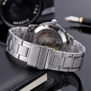 Detailed macro view of silver stainless steel watch strap and transparent case back