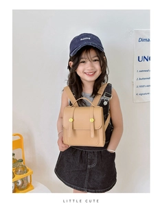 Detailed view of kids vintage khaki PU leather backpack with gold metal button accents