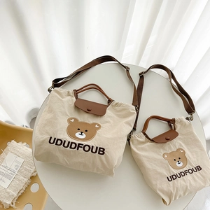 Cute cream canvas toddler tote bag with brown bear embroidery and adjustable shoulder strap