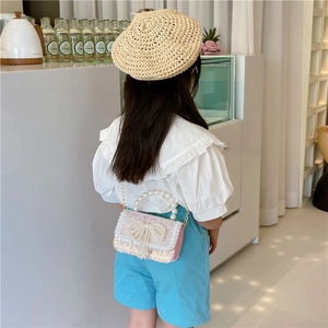 Pink and white tweed girls' crossbody bag featuring a pearl handle and bow detail