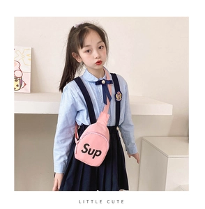 Pink canvas kids chest bag with black letter print shown on a girl in school outfit