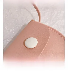 Close-up of pink PU leather kids bag showing white magnetic snap button and stitching