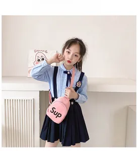 Detail show of pink canvas crossbody chest bag for kids with bold letter print