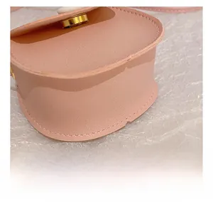 Close-up of precise stitching and gold magnetic clasp on pink PU leather mini bag