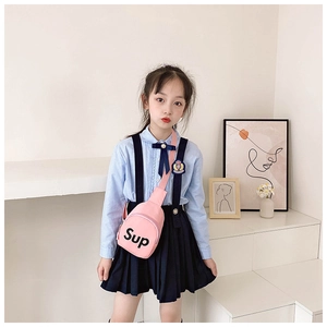 Detail of pink canvas chest bag with letter print and adjustable strap for kids