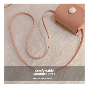 Detailed view of the pink faux leather mini bag featuring a slim comfortable shoulder strap