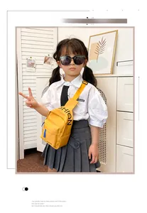 Detail of yellow canvas kids chest bag with fashion letter print and blue zipper puller