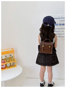 Detailed view of the brown vintage PU leather backpack with golden metal fasteners