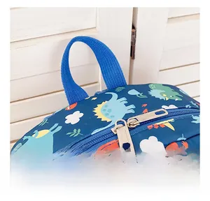 Detail of smooth double metal zippers and reinforced handle on cartoon dinosaur backpack