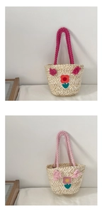 Detail of handmade straw bags for girls featuring colorful floral embroidery and handles