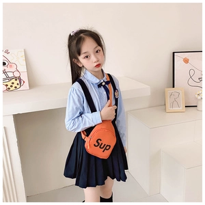 Close-up of orange kids' canvas chest bag with black adjustable strap and Sup print