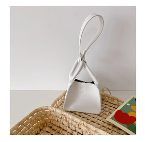 Detail of white lychee texture PU mini handbag with unique single loop handle design