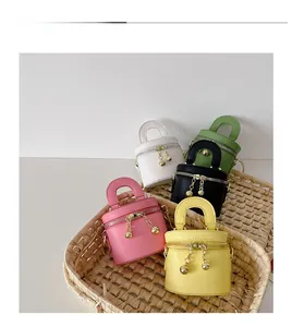 Vue détaillée de mini sacs seaux aux couleurs macaron dans un panier tressé