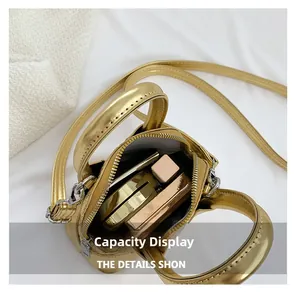 Interior view of the golden mini shell bag showing capacity for makeup and lipsticks