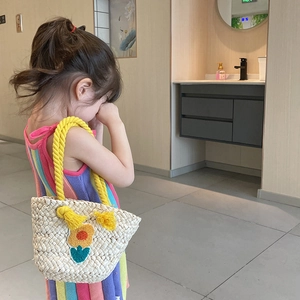 Handmade woven straw handbag for girls with yellow tassel handle and floral patch