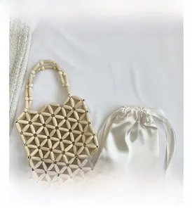 Detailed view of woven wooden beads and a satin drawstring inner bag for girls