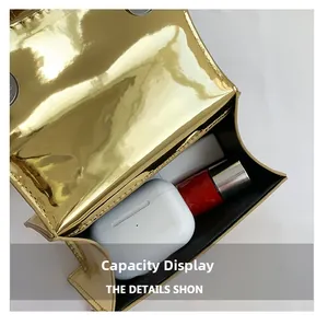 Detail of golden glossy mini bag interior showing space for earphones and lipstick