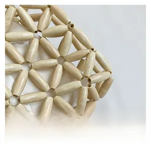 Macro detail of hand-woven cylindrical wooden beads with white satin lining texture