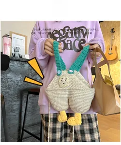 Detail of handmade crochet duck overall bag featuring pearl strap and 3D yellow webbed feet