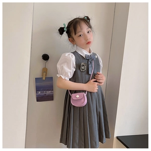 Detail of girls' preppy style outfit with purple crossbody bag and pleated vest dress