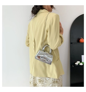 Silver mirror mini handbag with pearl bead chain strap shown on model shoulder
