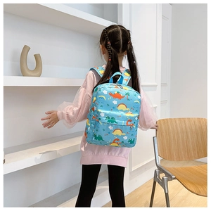 Detail view of sky blue toddler backpack with colorful cartoon dinosaur prints for kids