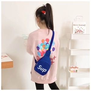 Rear view of a child wearing a blue canvas chest bag with white letter printing on it