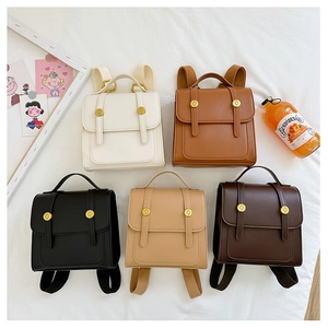 Flat lay of retro PU leather kids backpacks in five colors with vintage buckle details