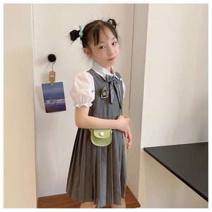 Detail of a green mini round crossbody bag paired with a girls' preppy school uniform outfit