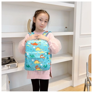 Front view of a light blue kids dinosaur backpack featuring adjustable straps and front pocket