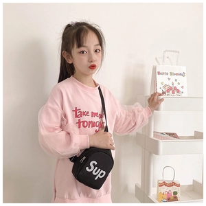 Detail of pink long-sleeve sweatshirt with mesh sleeves and a black crossbody bag