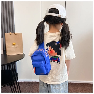 Close-up of blue canvas kids chest bag with orange SHION letters and zipper ribbon