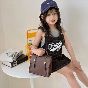 Vintage brown PU leather backpack for girls styled with a trendy denim jumper outfit