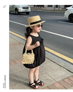 Chic child streetwear look with black puff bubble dress and a beaded handbag accessory