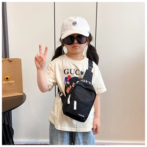 Detail view of black kids canvas chest bag with dual zippers and adjustable strap