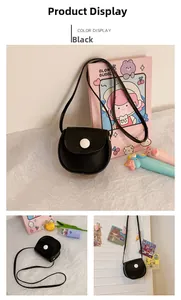 Detail view of mini black PU leather round crossbody bag with white buckle and slim strap
