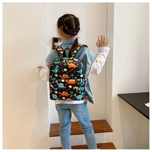 Detail of lightweight kids dinosaur backpack with colorful cartoon prints and front pocket