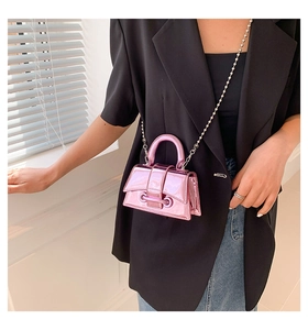 Pink metallic mini handbag shown as crossbody style with silver beaded chain strap