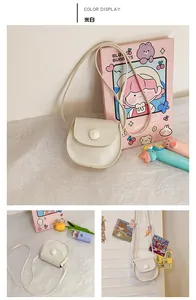 Detail view of mini PU leather round bag for girls in off-white with button closure