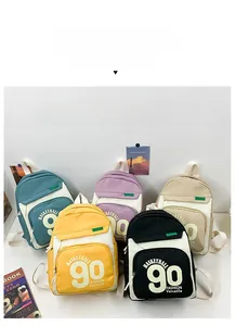 Gros plan détaillé montrant une collection de sacs à dos en toile en cinq couleurs pour enfants