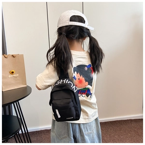 Close-up of children's black canvas chest bag featuring white FASHION letter print