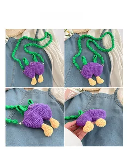 Detail view of handmade crochet mini bag with purple overall design and green straps