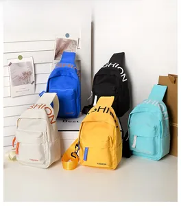 Macro shot of children's canvas crossbody bags in five colors with FASHION lettering