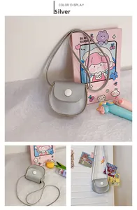 Silver mini PU leather crossbody bag for girls featuring a flap closure and round button
