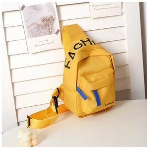 Detail of vibrant yellow canvas kids crossbody bag with black FASHION lettering
