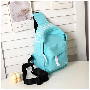 Detail of light blue canvas crossbody bag with white fashion letter print and strap buckle