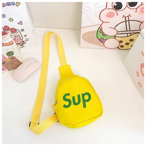Detail of yellow canvas kids chest bag featuring green Sup print and adjustable strap