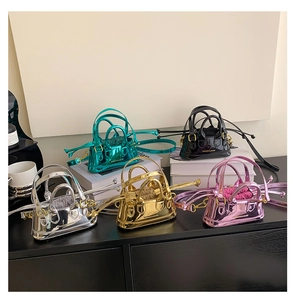 Close-up of colorful mini patent leather shell bags in silver, gold, pink, and green