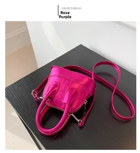 Detail of rose purple crocodile pattern mini shell bag with glossy metallic finish