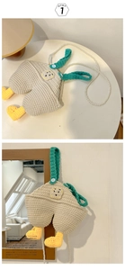 Detailed macro view of handmade crochet bib pants bag with pearl strap and knit textures